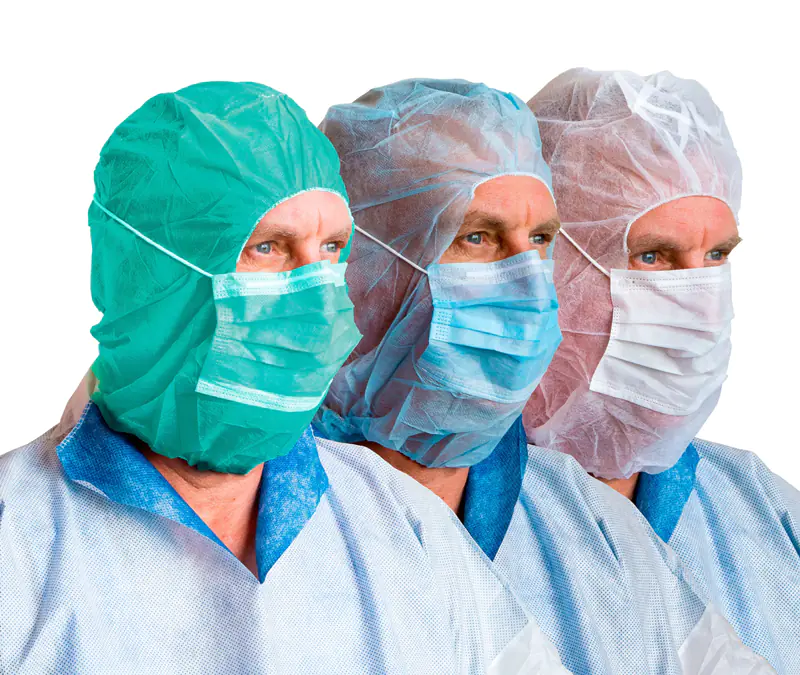 Three medical professionals wearing surgical masks and caps.