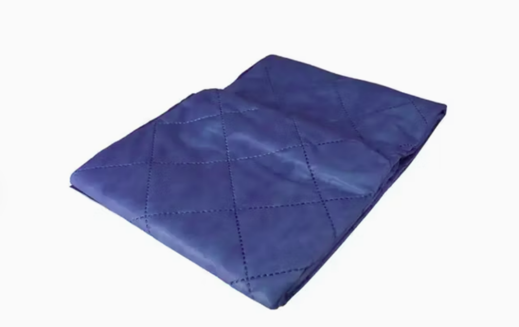 Folded blue quilted blanket with diamond pattern