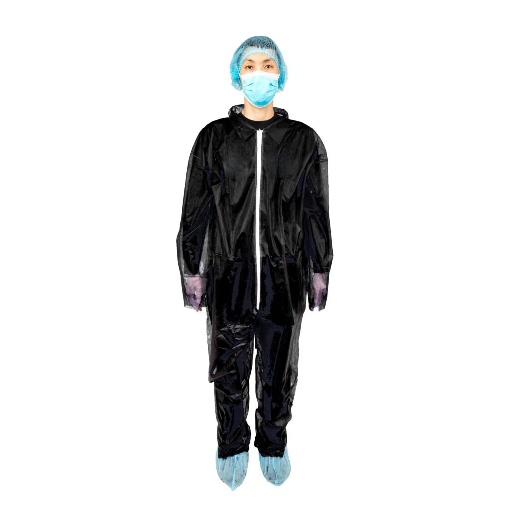 Person wearing black protective suit and mask