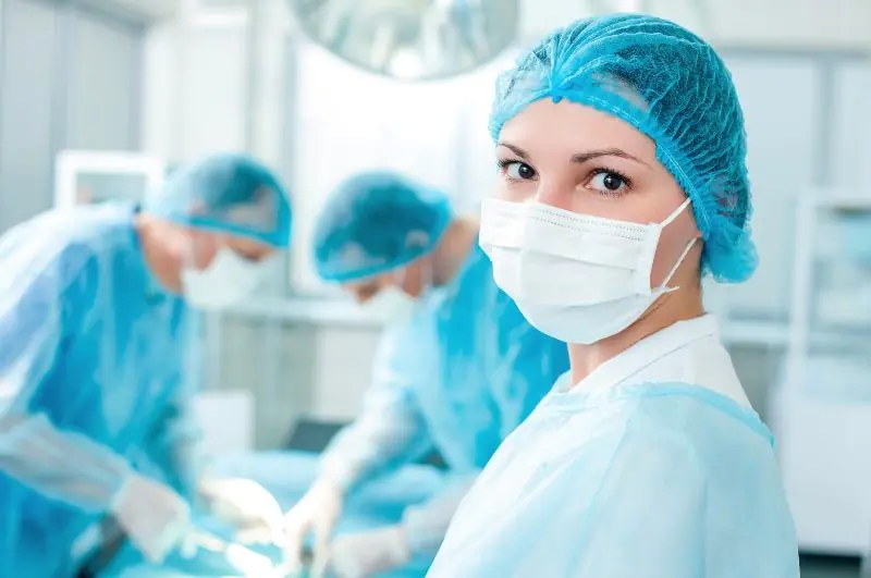 Surgeons performing an operation in sterile environment.