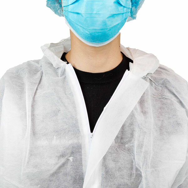 Person wearing surgical mask and protective gown