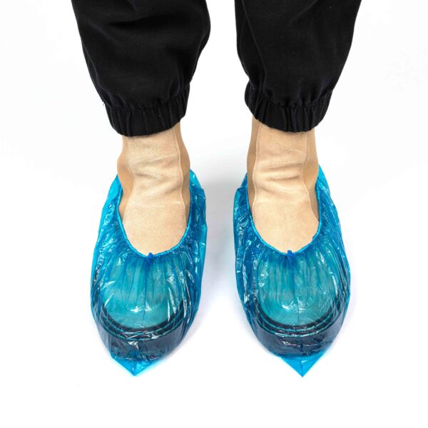 Feet wearing blue disposable shoe covers