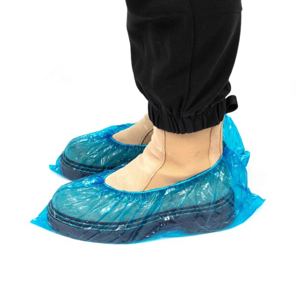 Boots covered with disposable blue shoe covers.