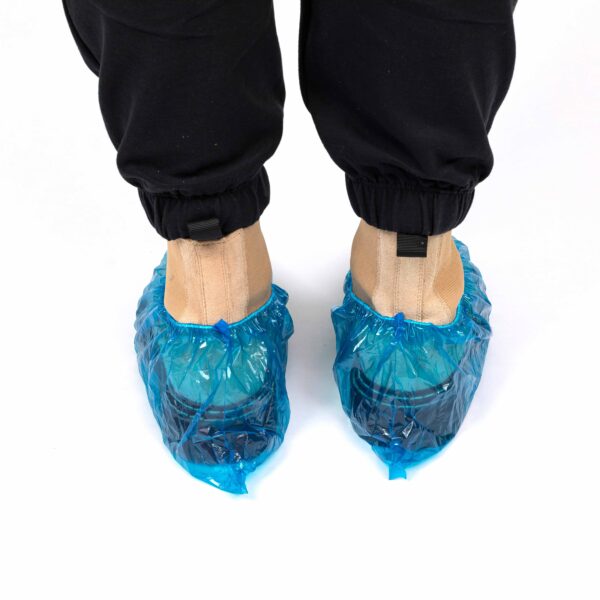 Shoes covered with blue protective covers