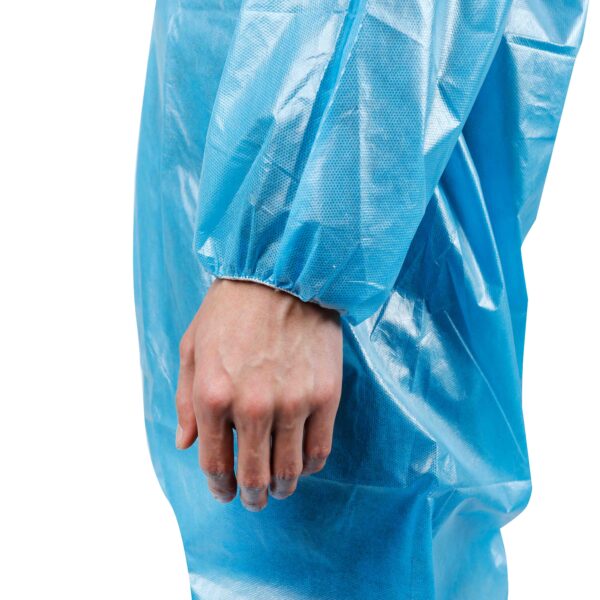 Hand wearing blue protective medical gown sleeve.