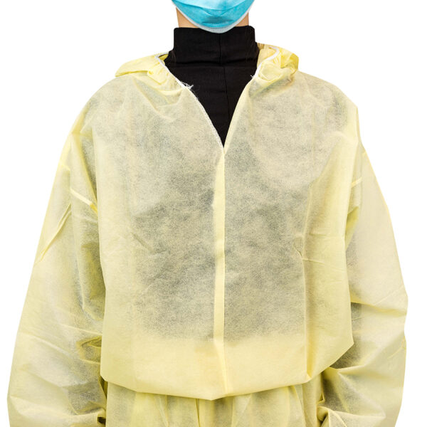 Person wearing yellow protective gown and mask