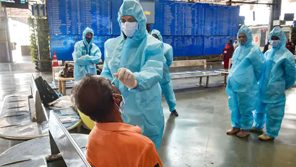 Healthcare worker conducting COVID-19 test at airport.
