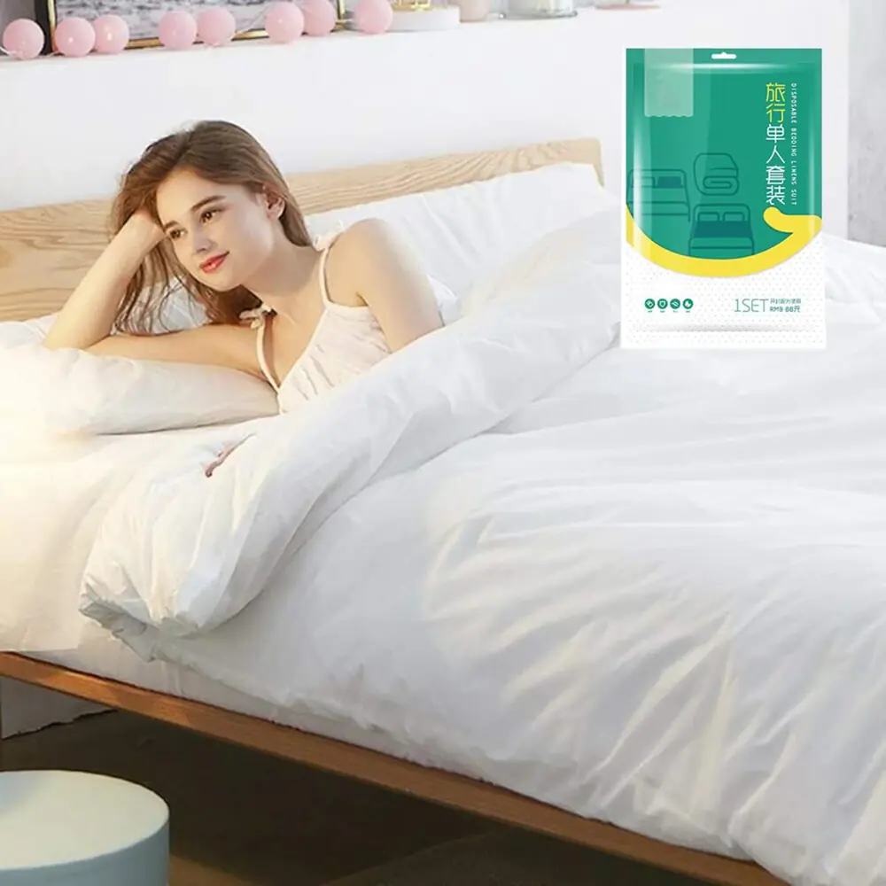 Woman relaxing in bed with white sheets.