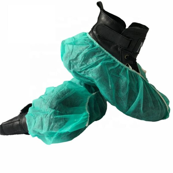 Black boots with green disposable shoe covers