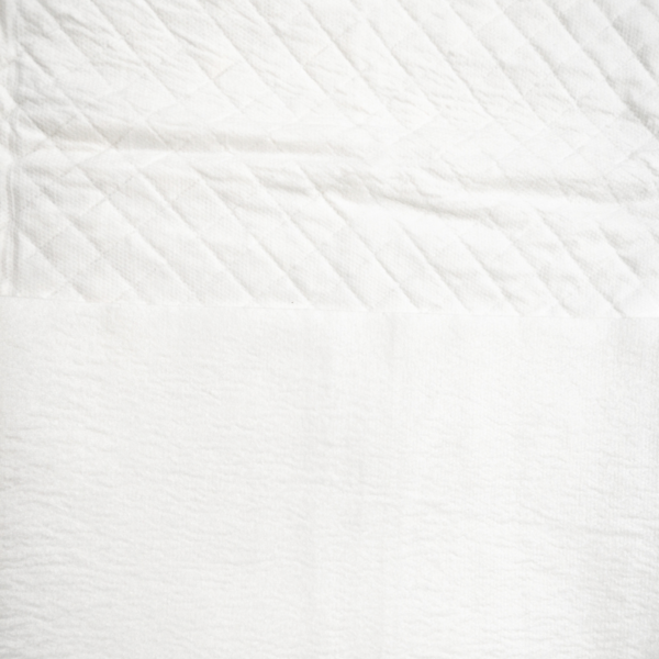 Close-up of quilted white fabric texture.