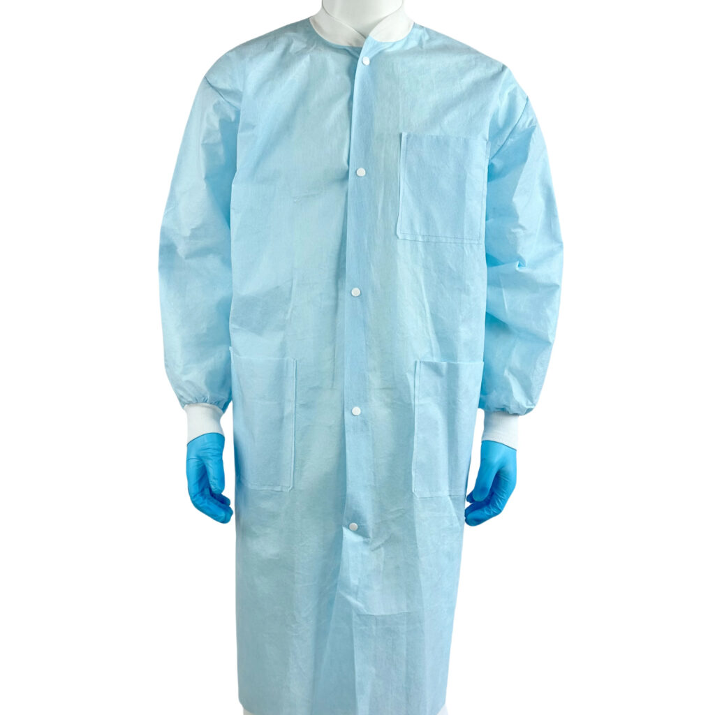 Person wearing blue disposable lab coat and gloves