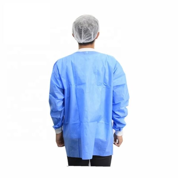 Person wearing blue medical gown and cap