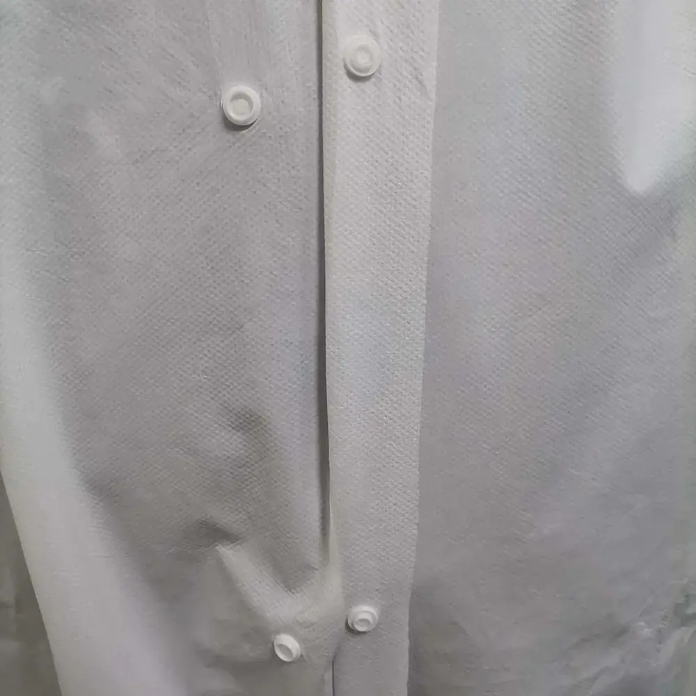Close-up of white garment with buttons