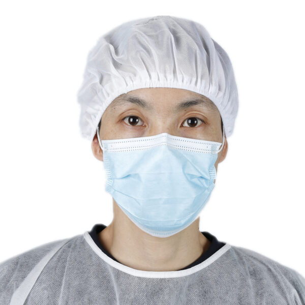 Person wearing blue surgical mask and bouffant cap.