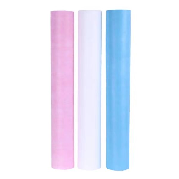 Three rolls of colored paper: pink, white, blue.