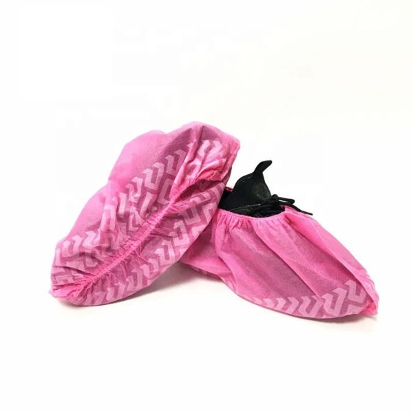 Pink disposable shoe covers on white background.