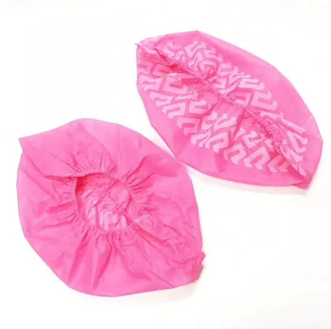 Two pink disposable hairnets on white background.