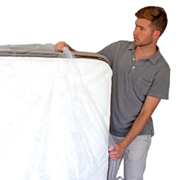 Man unwrapping a new mattress.