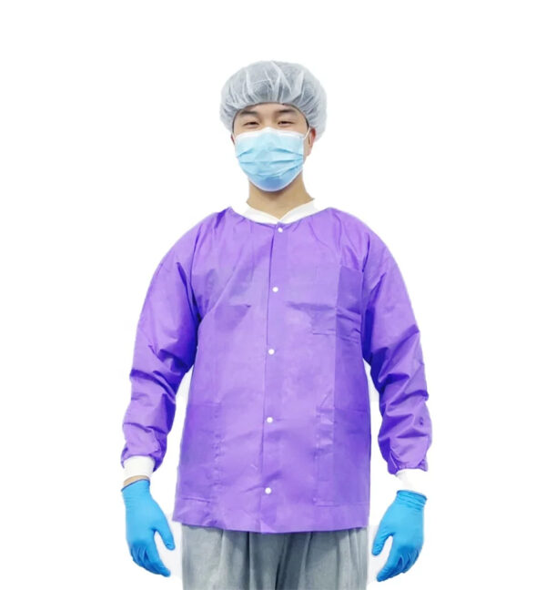 Person wearing purple scrubs and protective gear