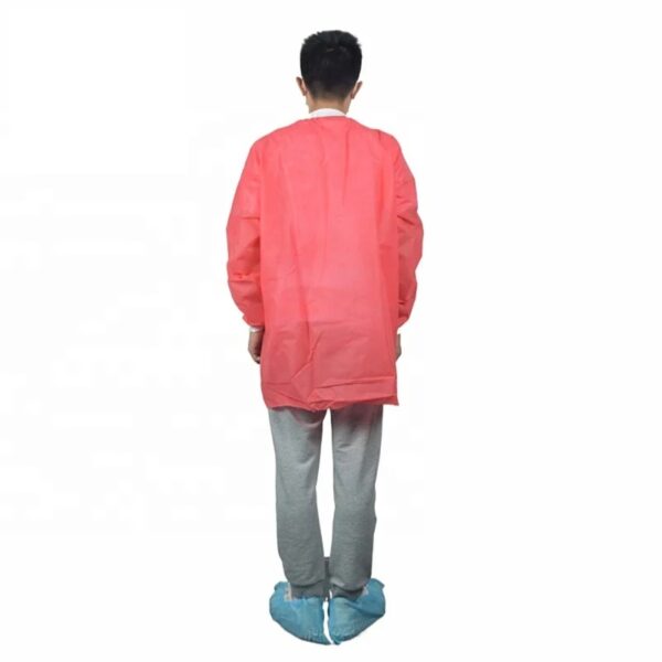 Person in pink lab coat and shoe covers