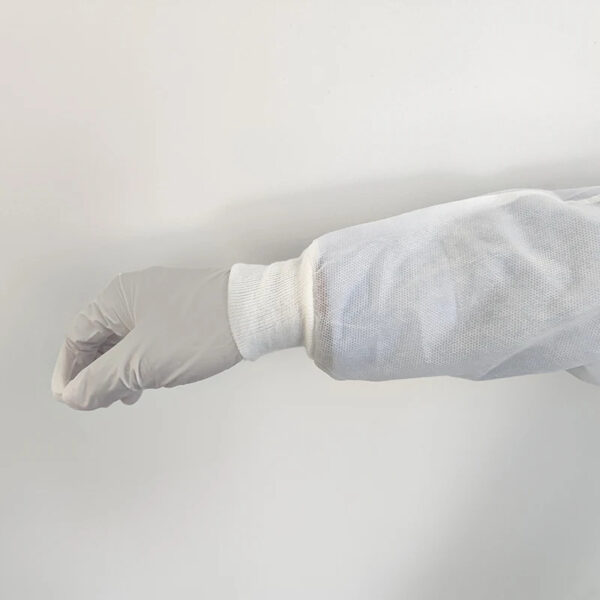 Arm wearing white protective glove and sleeve