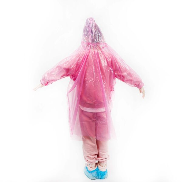 Person in pink rain poncho with arms outstretched.