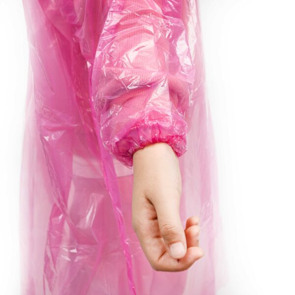 Person wearing a pink raincoat sleeve