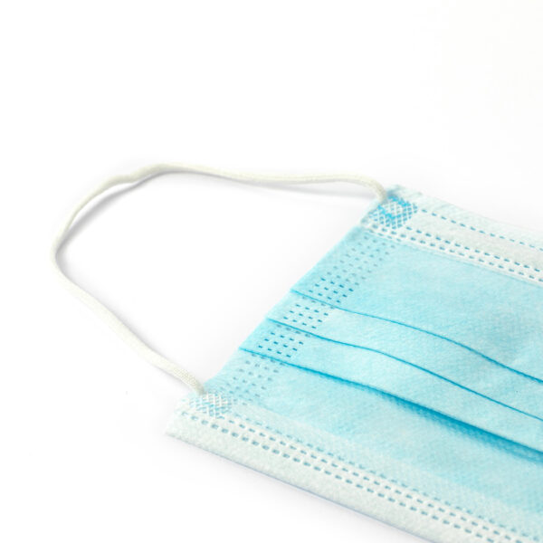 Blue disposable face mask on white background