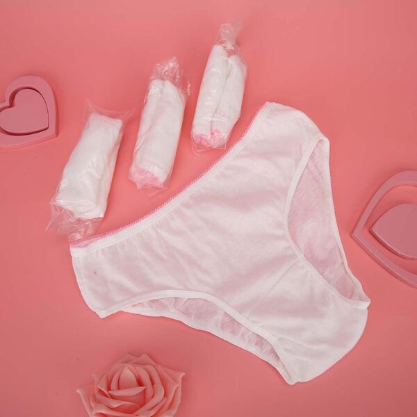 Women's underwear and tampons on pink background.