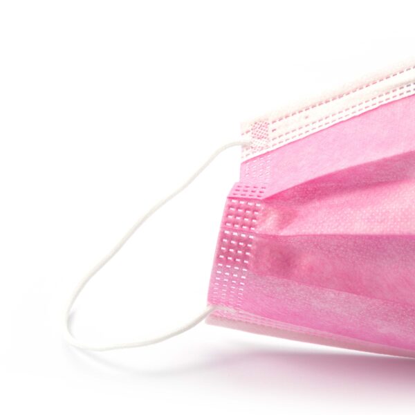 Pink disposable face mask on white background