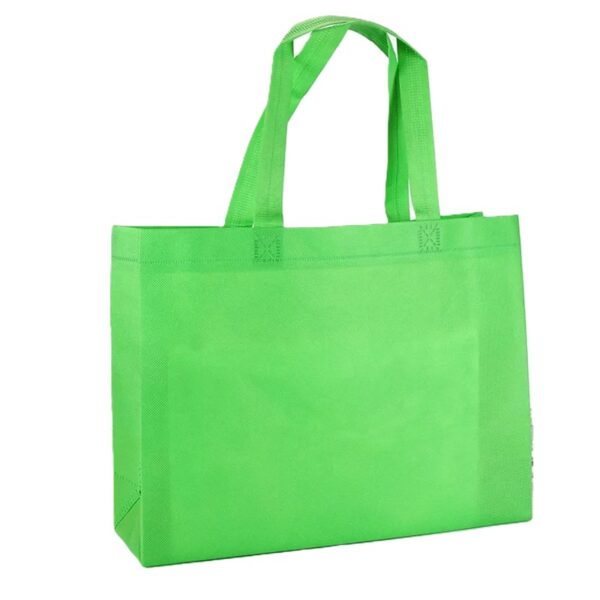 Green reusable shopping tote bag on white background.