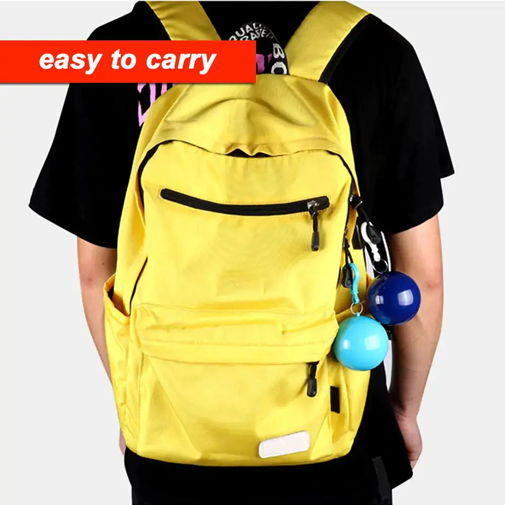 Person wearing a yellow backpack with charms.