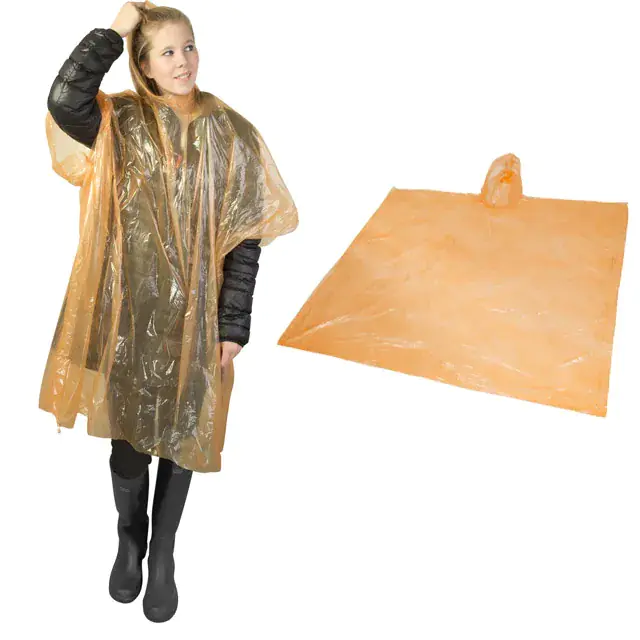 Woman wearing transparent rain poncho, orange poncho displayed.