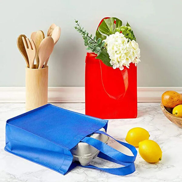 Reusable bags with groceries and utensils on counter.