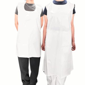 Two people wearing white aprons standing together.