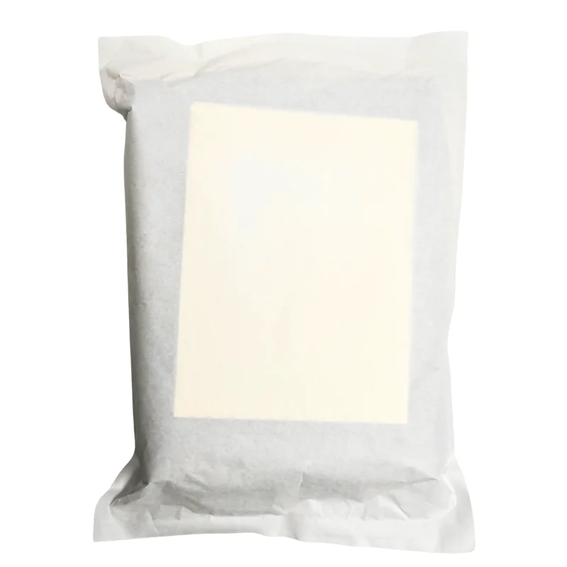 Sealed package of tofu on white background.