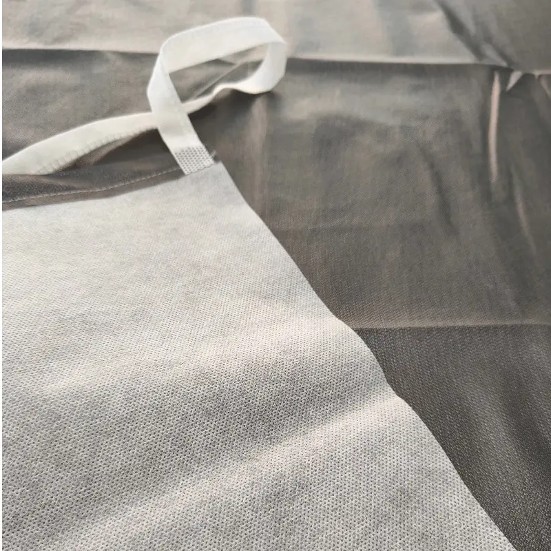 Gray fabric apron with white strap on display.