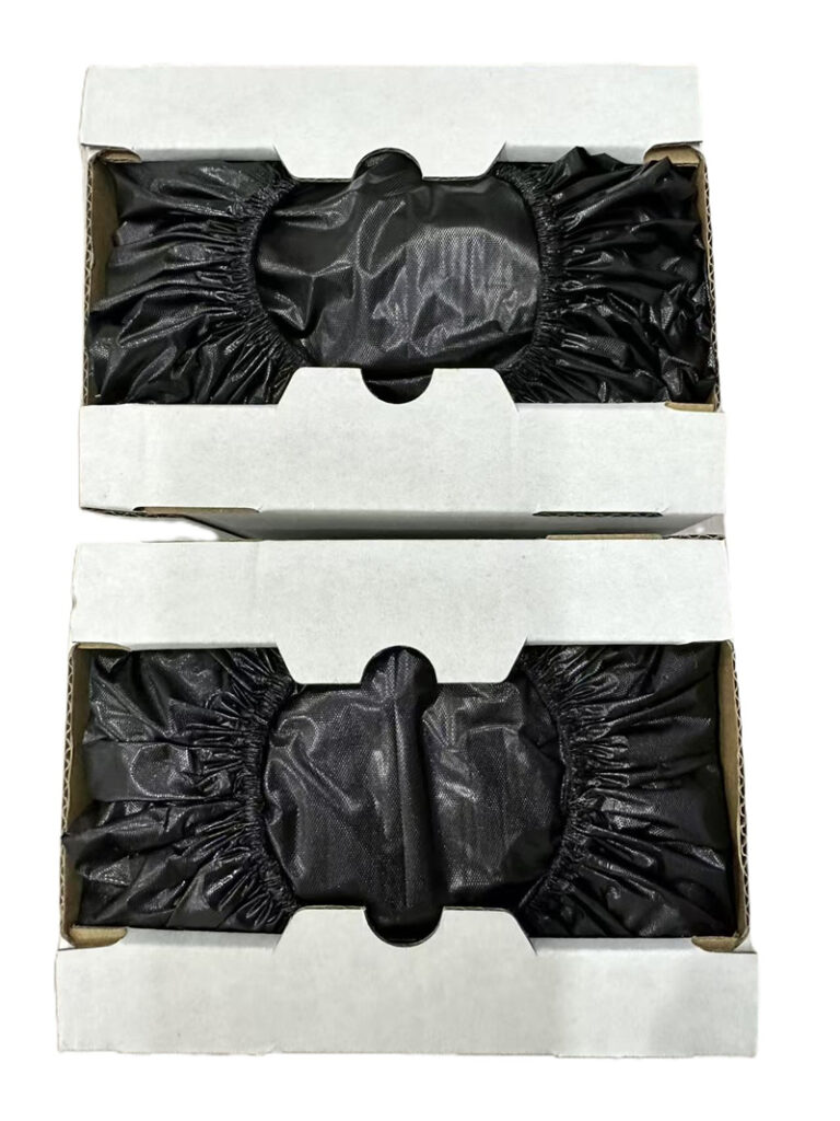 Two boxes of black disposable shoe covers.